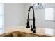 Modern kitchen faucet with granite countertop and stainless steel sink at 180 Oliver Dr, Locust Grove, GA 30248