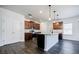 Well-lit kitchen with stainless steel appliances, dark wood cabinets, and a functional island at 180 Oliver Dr, Locust Grove, GA 30248