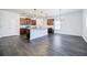 Open-concept living area featuring modern flooring, kitchen island, and stainless appliances at 180 Oliver Dr, Locust Grove, GA 30248