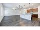 Open-concept living area featuring modern flooring, kitchen island, and stainless appliances at 180 Oliver Dr, Locust Grove, GA 30248