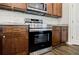 Stainless steel oven and dark wood cabinets with granite countertop in kitchen at 180 Oliver Dr, Locust Grove, GA 30248