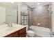 This bathroom features a tub, a sink and a mirror, all complemented by decorative tile at 2149 Shoop Se Ct # 3, Smyrna, GA 30080