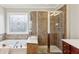 Ensuite bathroom featuring a separate tub, and a glass-enclosed shower, as well as dual vanities at 2149 Shoop Se Ct # 3, Smyrna, GA 30080