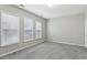 Bright, airy bedroom featuring three large windows and plush carpet flooring at 2149 Shoop Se Ct # 3, Smyrna, GA 30080