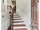 Inviting entryway with hardwood stairs, white wainscoting, and iron railing at 2149 Shoop Se Ct # 3, Smyrna, GA 30080