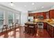 Bright eat-in kitchen with cherry cabinets, stainless steel appliances, hardwood floors, and island with seating at 2149 Shoop Se Ct # 3, Smyrna, GA 30080