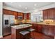 Cozy kitchen with granite countertops, stainless steel appliances, island with bar stool seating and decorative tile backsplash at 2149 Shoop Se Ct # 3, Smyrna, GA 30080