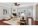 Cozy living room featuring a fireplace, ceiling fan, and hardwood floors at 2149 Shoop Se Ct # 3, Smyrna, GA 30080