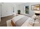 Bright staged bedroom with wood-look floors, a neutral color scheme, and ample natural light at 607 Park Ridge Cir, Marietta, GA 30068