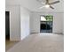Bedroom with neutral-colored carpet, ceiling fan, and sliding glass doors to a private patio at 607 Park Ridge Cir, Marietta, GA 30068