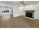 Large living room featuring fireplace, built-in shelving, wood laminate flooring and views to sunroom at 607 Park Ridge Cir, Marietta, GA 30068