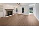 Spacious living room featuring a fireplace, built-in shelving, hardwood floors, and large windows at 607 Park Ridge Cir, Marietta, GA 30068