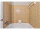 Bathroom featuring a white bathtub and shower with traditional tan tile at 745 Greenvine Pl, Roswell, GA 30076
