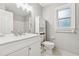 Updated bathroom with modern fixtures, white vanity, and ample storage at 745 Greenvine Pl, Roswell, GA 30076