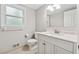 Updated bathroom with white vanity, marble countertop, and modern fixtures at 745 Greenvine Pl, Roswell, GA 30076