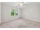 Cozy bedroom with neutral carpet, large window, and ceiling fan at 745 Greenvine Pl, Roswell, GA 30076