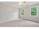 Comfortable bedroom with plush carpet, natural light, and ample space at 745 Greenvine Pl, Roswell, GA 30076