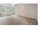 Spacious bedroom with neutral carpet, natural light, and ample closet space at 745 Greenvine Pl, Roswell, GA 30076