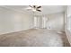 Large bedroom with neutral carpet, paneled walls, and ensuite bathroom at 745 Greenvine Pl, Roswell, GA 30076