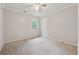 Bright bedroom with a ceiling fan, neutral walls and soft carpet flooring at 745 Greenvine Pl, Roswell, GA 30076