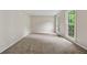 Bright and airy bedroom with neutral carpet, two windows, and freshly painted walls at 745 Greenvine Pl, Roswell, GA 30076