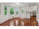 Light-filled dining area with hardwood floors, large windows, and adjacent kitchen access at 745 Greenvine Pl, Roswell, GA 30076