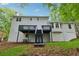 Two-story home featuring a ground level entrance, deck and stairs at 745 Greenvine Pl, Roswell, GA 30076