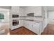 Charming kitchen with white cabinets, stainless steel appliances, and granite countertops at 745 Greenvine Pl, Roswell, GA 30076