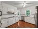 Updated kitchen with granite countertops, stainless steel appliances, and white cabinetry at 745 Greenvine Pl, Roswell, GA 30076