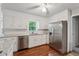 Beautifully updated kitchen with stainless steel appliances and white cabinetry at 745 Greenvine Pl, Roswell, GA 30076
