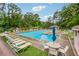 Community pool with sun loungers, umbrella tables and bright blue water at 745 Greenvine Pl, Roswell, GA 30076