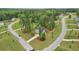 An aerial view shows the lovely home with manicured landscaping and a long driveway nestled amongst the trees at 130 W Pier Way, Fayetteville, GA 30214
