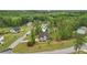 An aerial view shows the lovely home with manicured landscaping and a long driveway nestled amongst the trees at 130 W Pier Way, Fayetteville, GA 30214