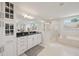 Elegant bathroom featuring double vanities, a glass-enclosed shower, and a soaking tub at 130 W Pier Way, Fayetteville, GA 30214