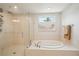 Beautiful bathroom featuring a glass enclosed shower and a soaking tub under a window at 130 W Pier Way, Fayetteville, GA 30214