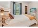 Bright bedroom featuring a queen bed, stylish lamps, and a window with sheer curtains at 130 W Pier Way, Fayetteville, GA 30214