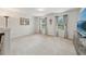 Spacious bonus room with neutral carpet, large windows and a wall-mounted television at 130 W Pier Way, Fayetteville, GA 30214