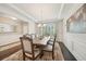 Formal dining room featuring wainscoting, dark hardwood floors, and a large window with natural light at 130 W Pier Way, Fayetteville, GA 30214