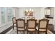Formal dining room featuring wainscoting, dark hardwood floors, and a large window with natural light at 130 W Pier Way, Fayetteville, GA 30214