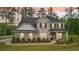 Beautiful two-story home featuring a combination of stone and brick, a dark roof, and a neatly landscaped front yard at 130 W Pier Way, Fayetteville, GA 30214
