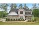 Beautiful two-story home featuring a combination of stone and brick, a dark roof, and a neatly landscaped front yard at 130 W Pier Way, Fayetteville, GA 30214