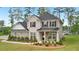 Attractive two-story home with brick and siding, complemented by a well-manicured lawn and mature landscaping at 130 W Pier Way, Fayetteville, GA 30214