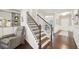 Inviting foyer featuring hardwood floors, staircase with iron balusters, and views of a study at 130 W Pier Way, Fayetteville, GA 30214