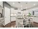 Bright kitchen featuring a dark countertop island, stainless steel appliances, and white cabinetry at 130 W Pier Way, Fayetteville, GA 30214