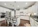 Well-lit kitchen with stainless steel appliances, a dark countertop island, and white cabinets at 130 W Pier Way, Fayetteville, GA 30214