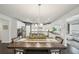 Bright kitchen with stainless steel appliances, a dark countertop island, and wooden dining table set at 130 W Pier Way, Fayetteville, GA 30214