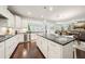 Stylish kitchen with a dark countertop island and stainless steel appliances, flowing into the dining area at 130 W Pier Way, Fayetteville, GA 30214