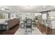 Open-concept kitchen with dining area featuring stainless appliances and hardwood floors at 130 W Pier Way, Fayetteville, GA 30214