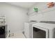 A laundry room equipped with a washer and dryer and storage shelves at 130 W Pier Way, Fayetteville, GA 30214