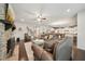 Spacious living room with a stone fireplace, hardwood floors, and open access to the kitchen at 130 W Pier Way, Fayetteville, GA 30214